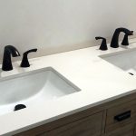 Faucet and drain installation for dual vanity.